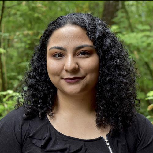 Headshot of Nariman Elshamma smiling in the forest.