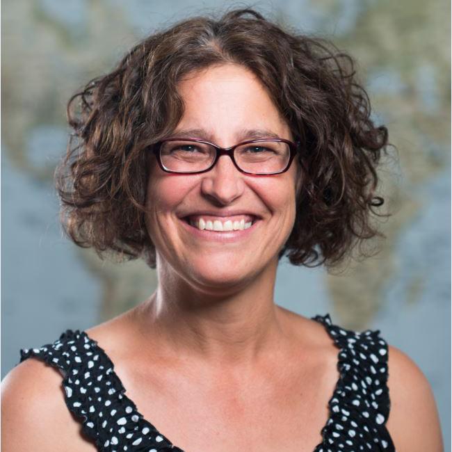 Profile photo of Julie Beschta in front of world map